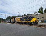 WAMX 3021 pulling boxcars in town